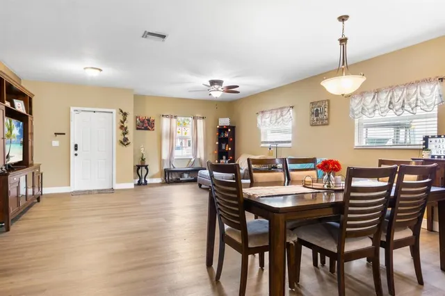 a view of a dining room with furniture and wooden floor