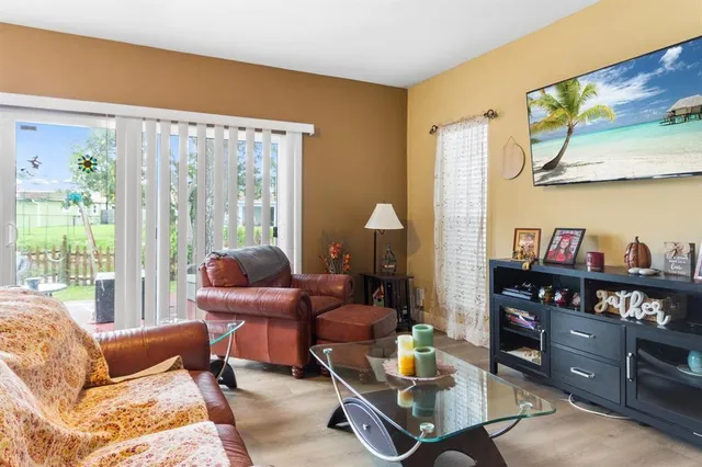 a living room with furniture and a floor to ceiling window