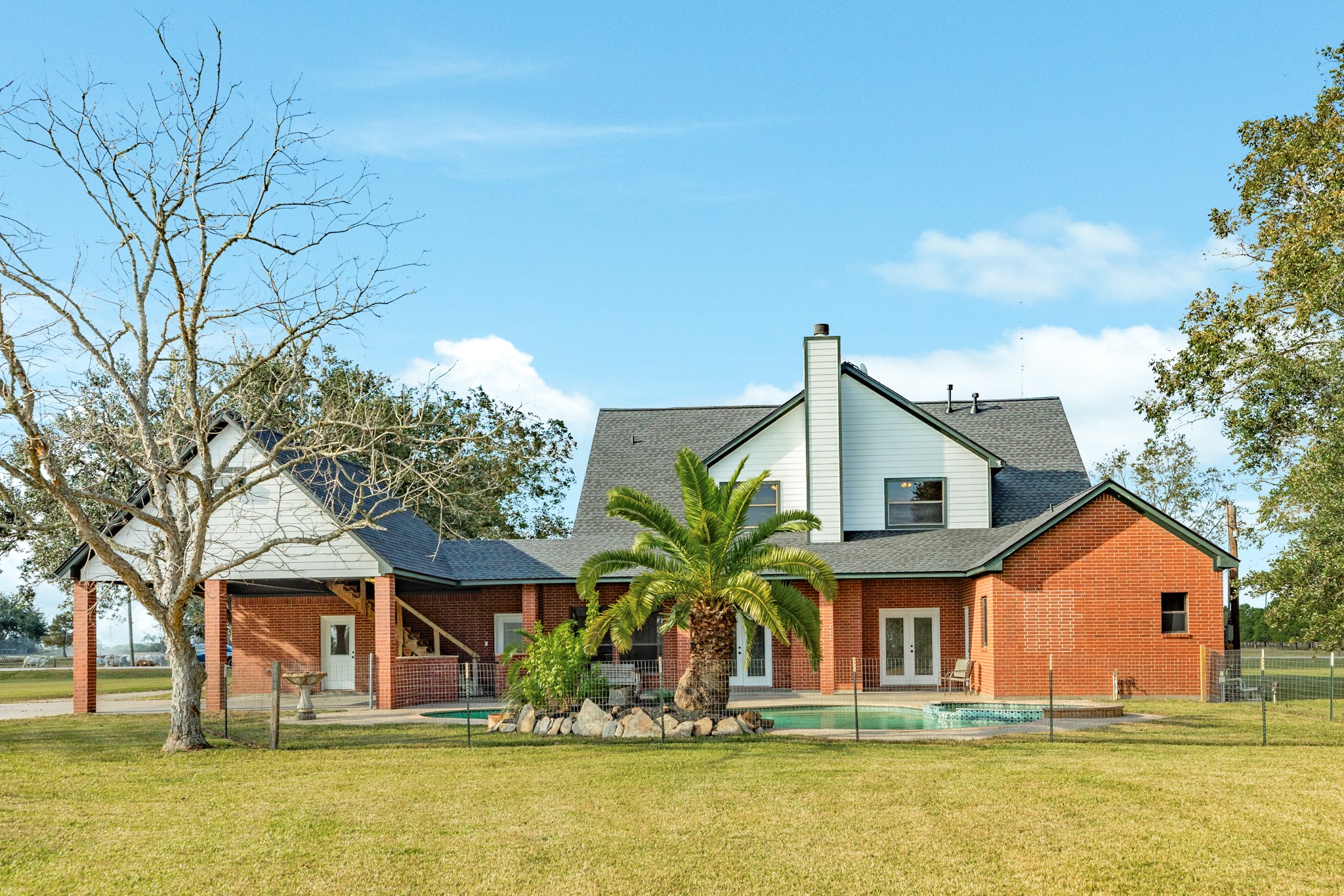 310 County Road 47 Angleton, TX 77515 - Photo 13 of 50 a front view of house with small garden in front of it