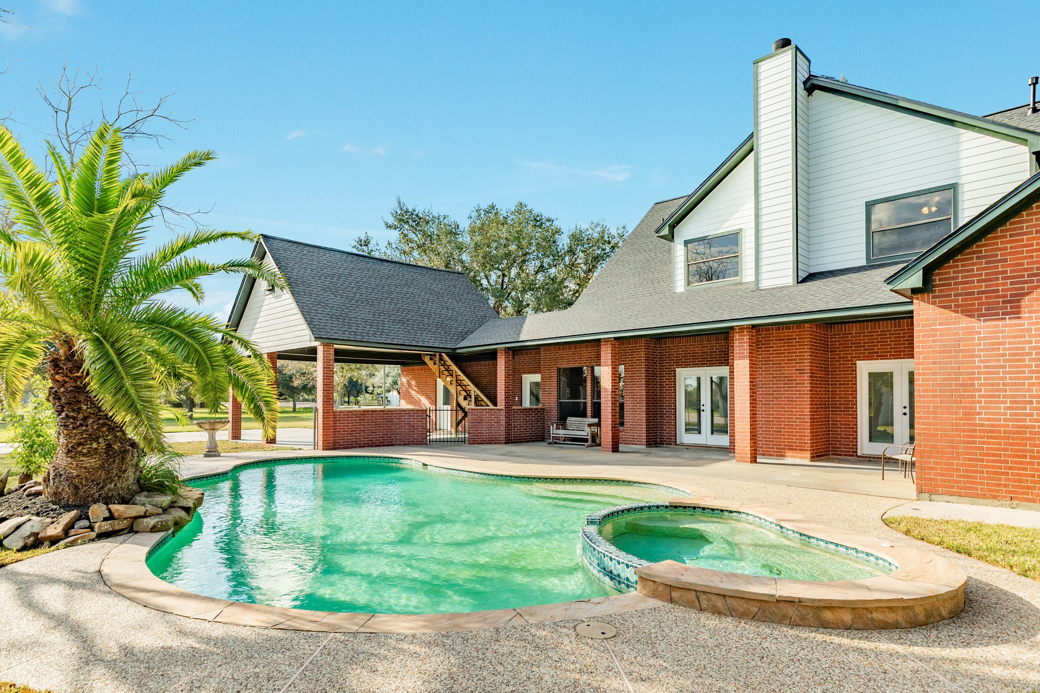310 County Road 47 Angleton, TX 77515 - Photo 15 of 50 a view of a house with a swimming pool