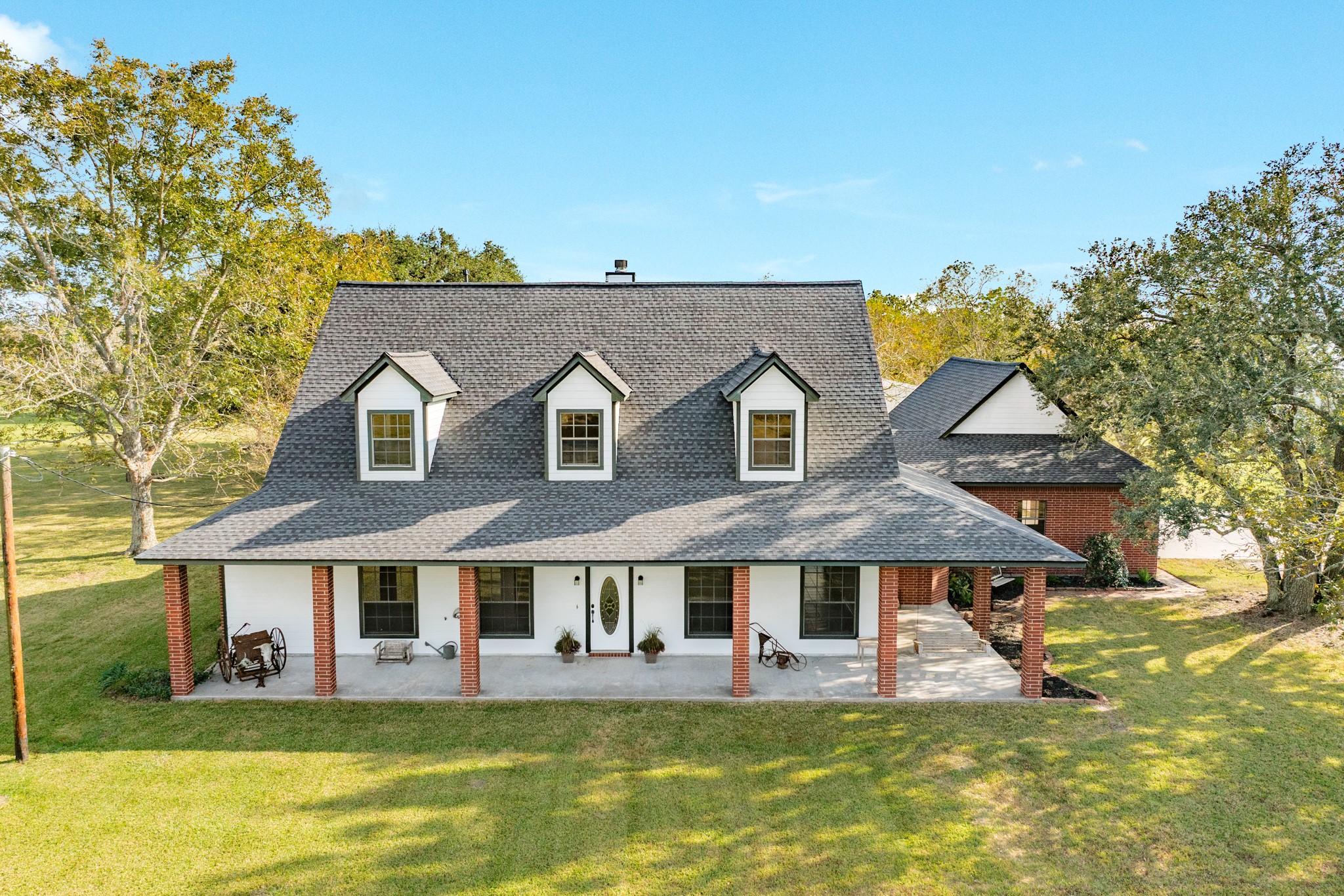 310 County Road 47 Angleton, TX 77515 - Photo 2 of 50 a view of a white house with a big yard and large trees