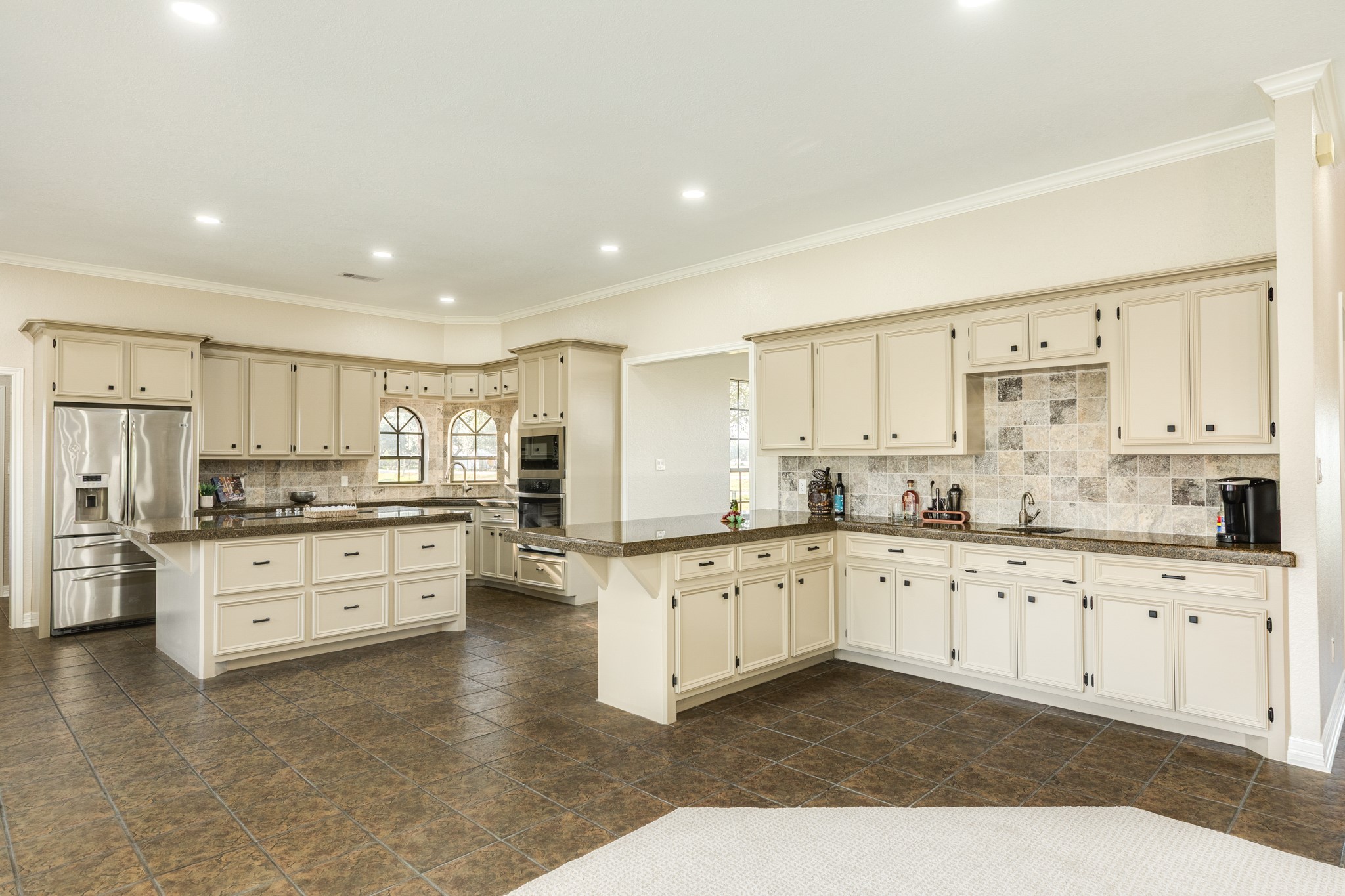 310 County Road 47 Angleton, TX 77515 - Photo 24 of 50 a large kitchen with granite countertop a large counter top space appliances and cabinets