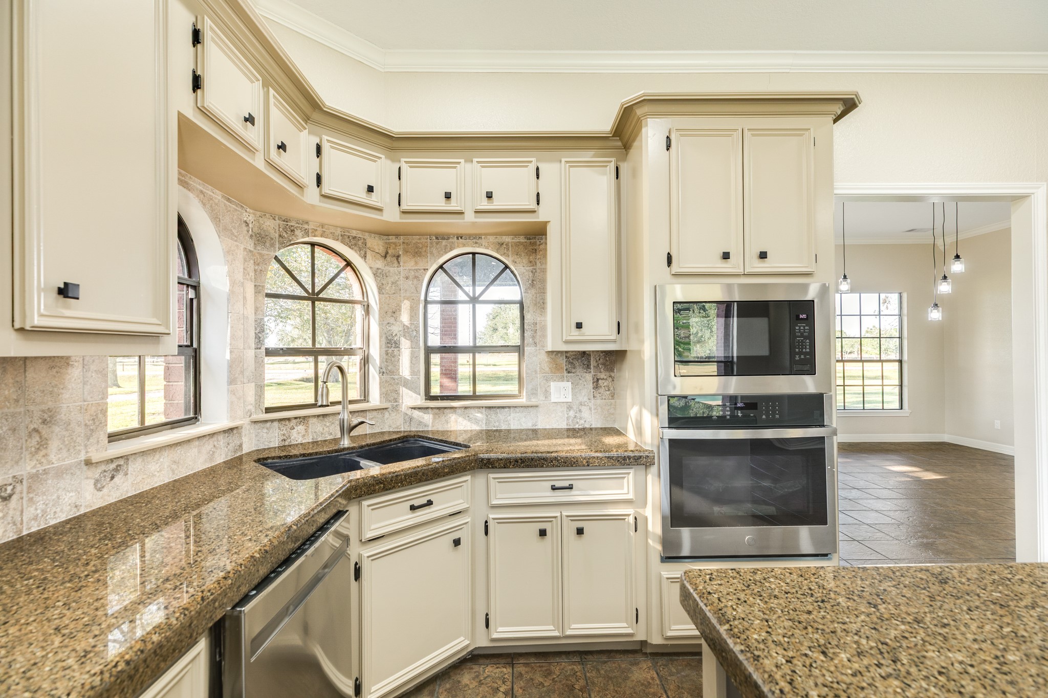 310 County Road 47 Angleton, TX 77515 - Photo 28 of 50 a kitchen with stainless steel appliances granite countertop a stove a sink and a granite counter tops with white cabinets
