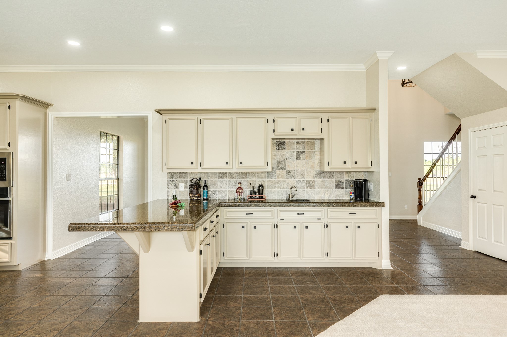 310 County Road 47 Angleton, TX 77515 - Photo 30 of 50 a kitchen with granite countertop a stove and white cabinets