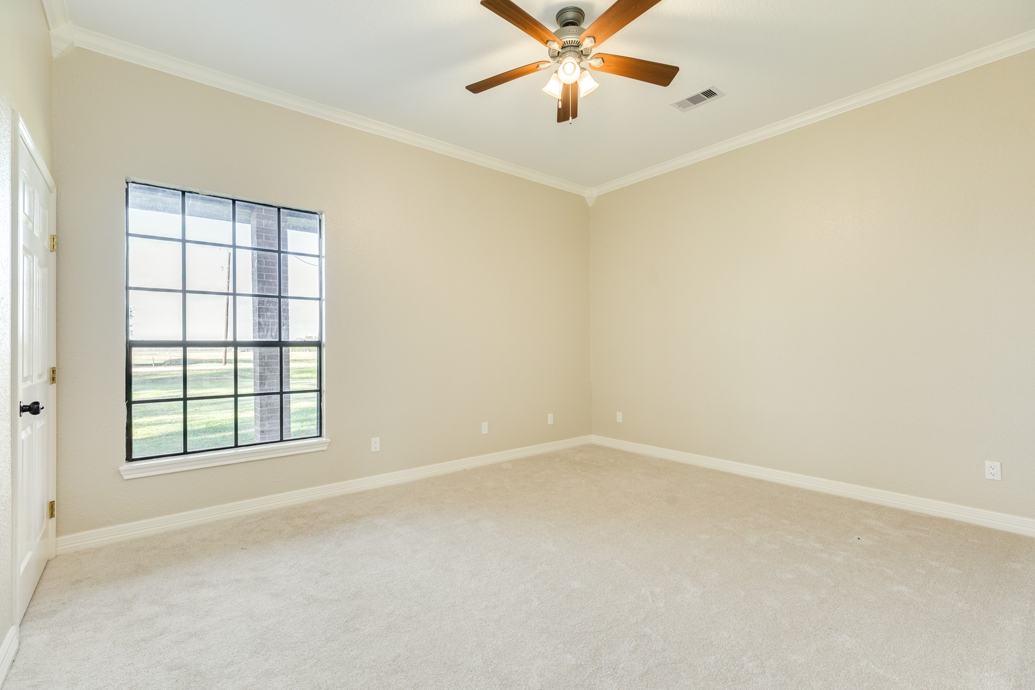 310 County Road 47 Angleton, TX 77515 - Photo 39 of 50 an empty room with windows and fan