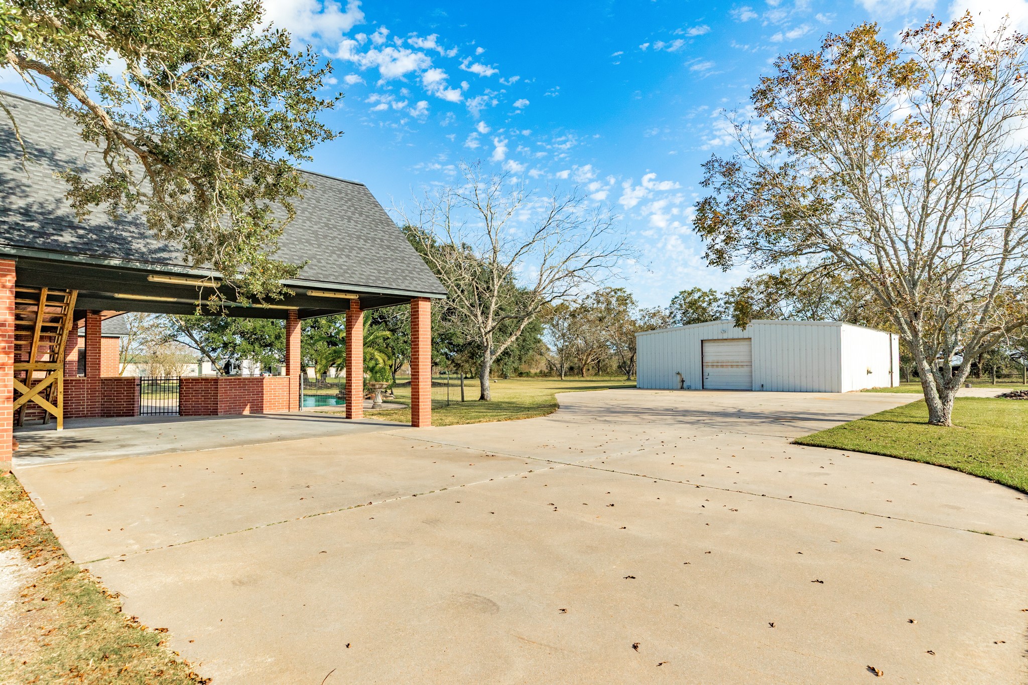 310 County Road 47 Angleton, TX 77515 - Photo 10 of 50 a front view of a house with a yard and garage