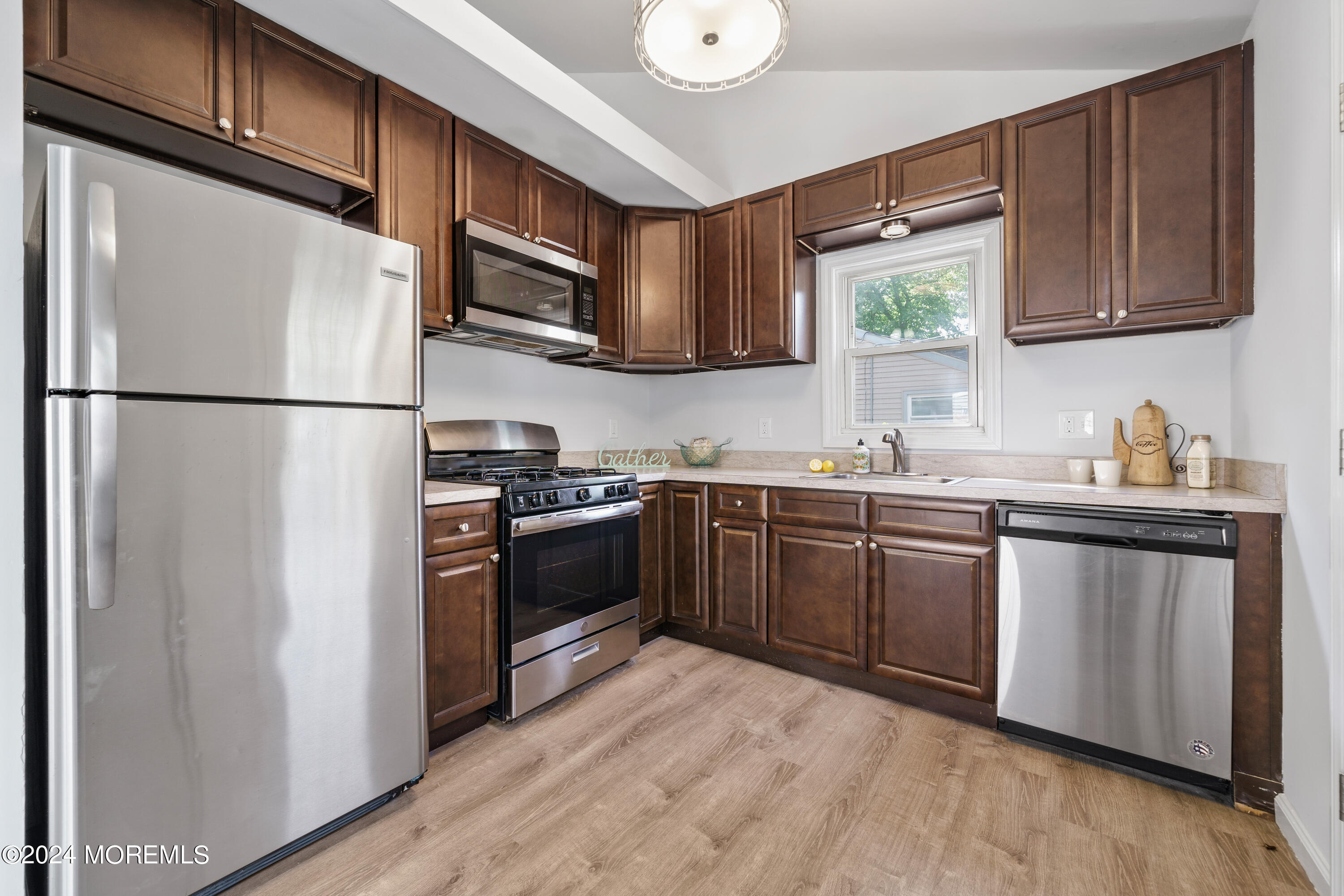 50 Dock Avenue Waretown, NJ 08758 - Photo 11 of 19 a kitchen with granite countertop a refrigerator stove top oven and sink