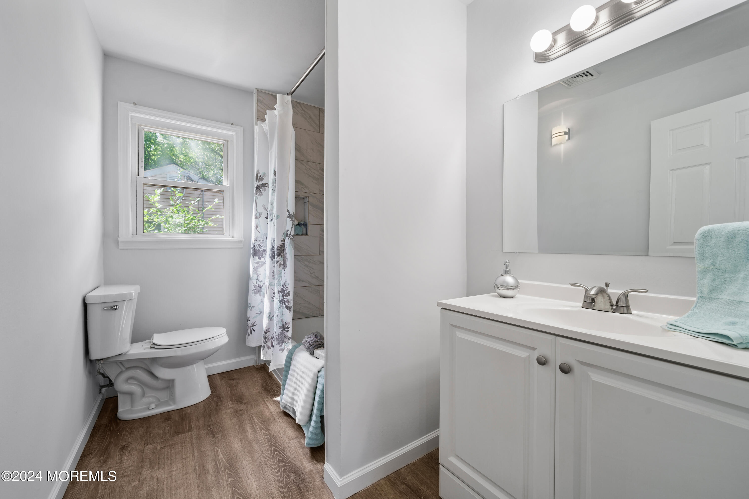 50 Dock Avenue Waretown, NJ 08758 - Photo 15 of 19 a bathroom with a granite countertop toilet a sink and a mirror