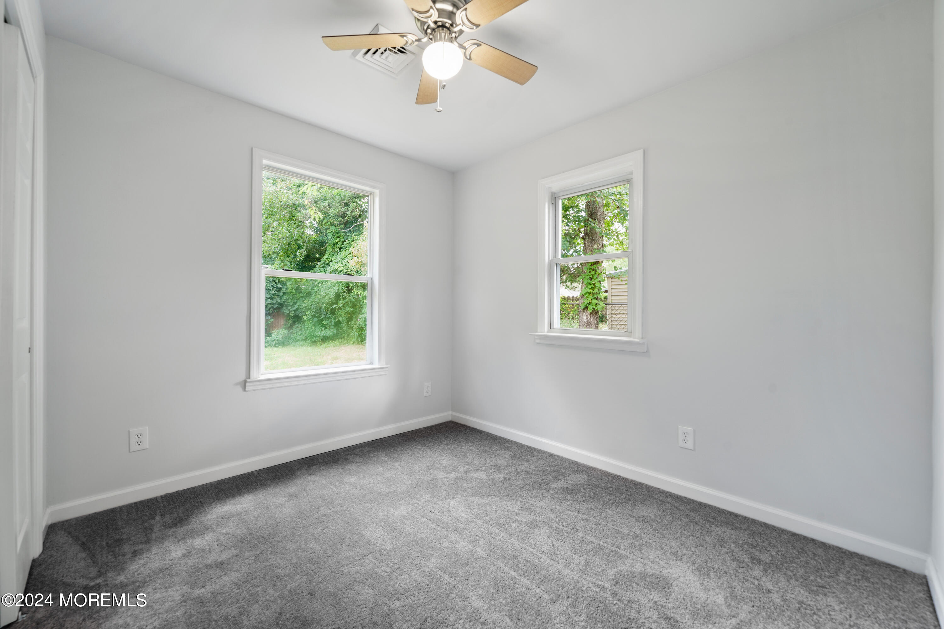 50 Dock Avenue Waretown, NJ 08758 - Photo 19 of 19 an empty room with windows and fan