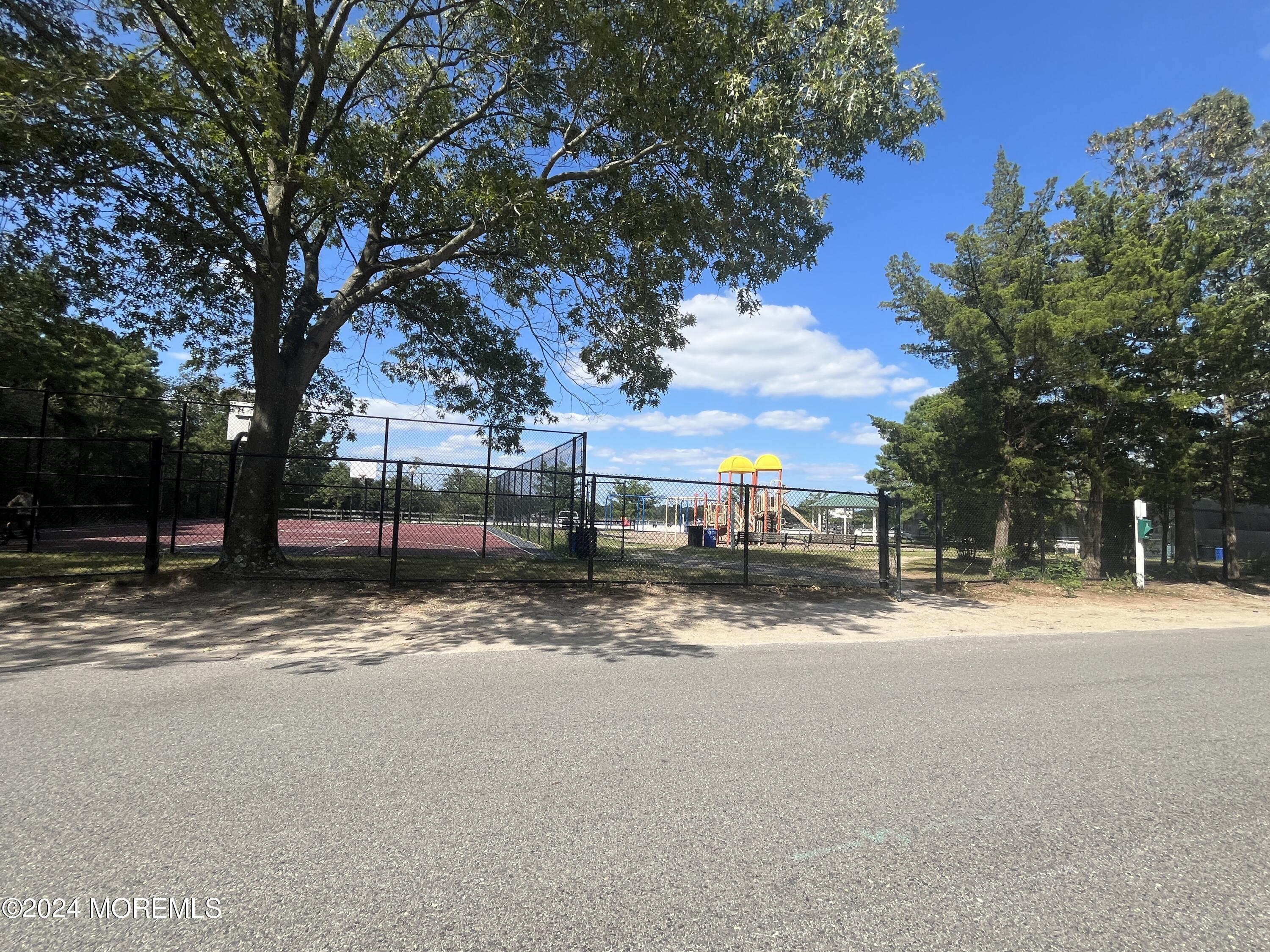 50 Dock Avenue Waretown, NJ 08758 - Photo 3 of 19 a view of a road with a large trees