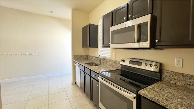 a kitchen with a stove and a microwave