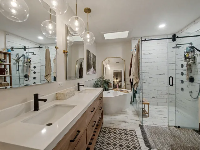 a bathroom with a double vanity sink mirror and shower