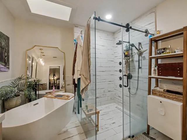 a spacious bathroom with a bathtub shower and a sink