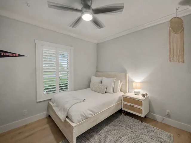 a bedroom with a bed and a chandelier