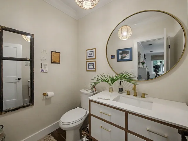a bathroom with a toilet a sink and mirror