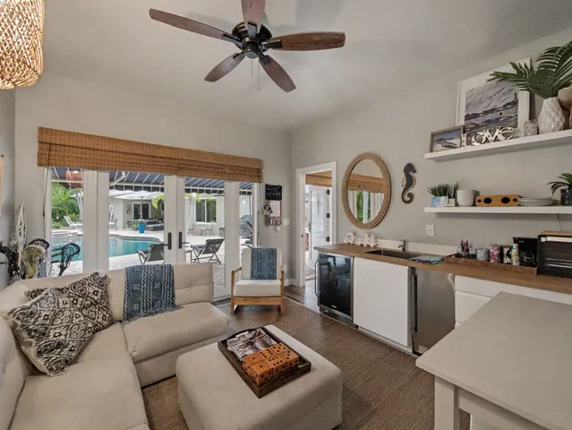 a living room with furniture a rug and a window