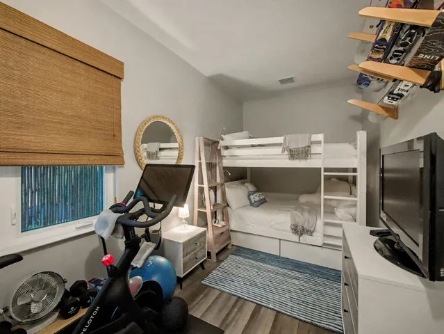 a living room with furniture a flat screen tv and a floor to ceiling window