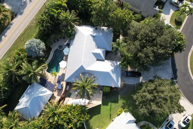 an aerial view of a house with a yard and garden
