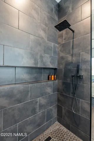 a bed sitting in a spacious bedroom next to a window