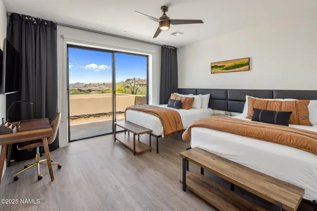 a bedroom with bed and a large window