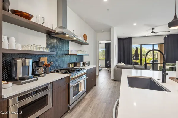 a living room with furniture and kitchen view