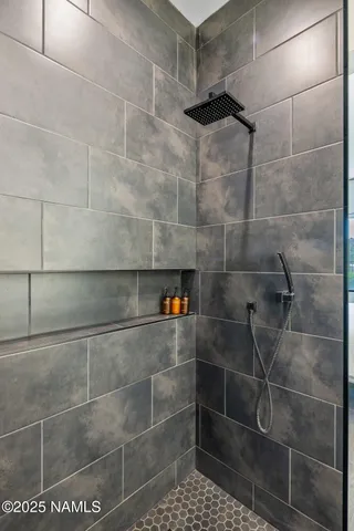 a bathroom with a sink a shower and a mirror