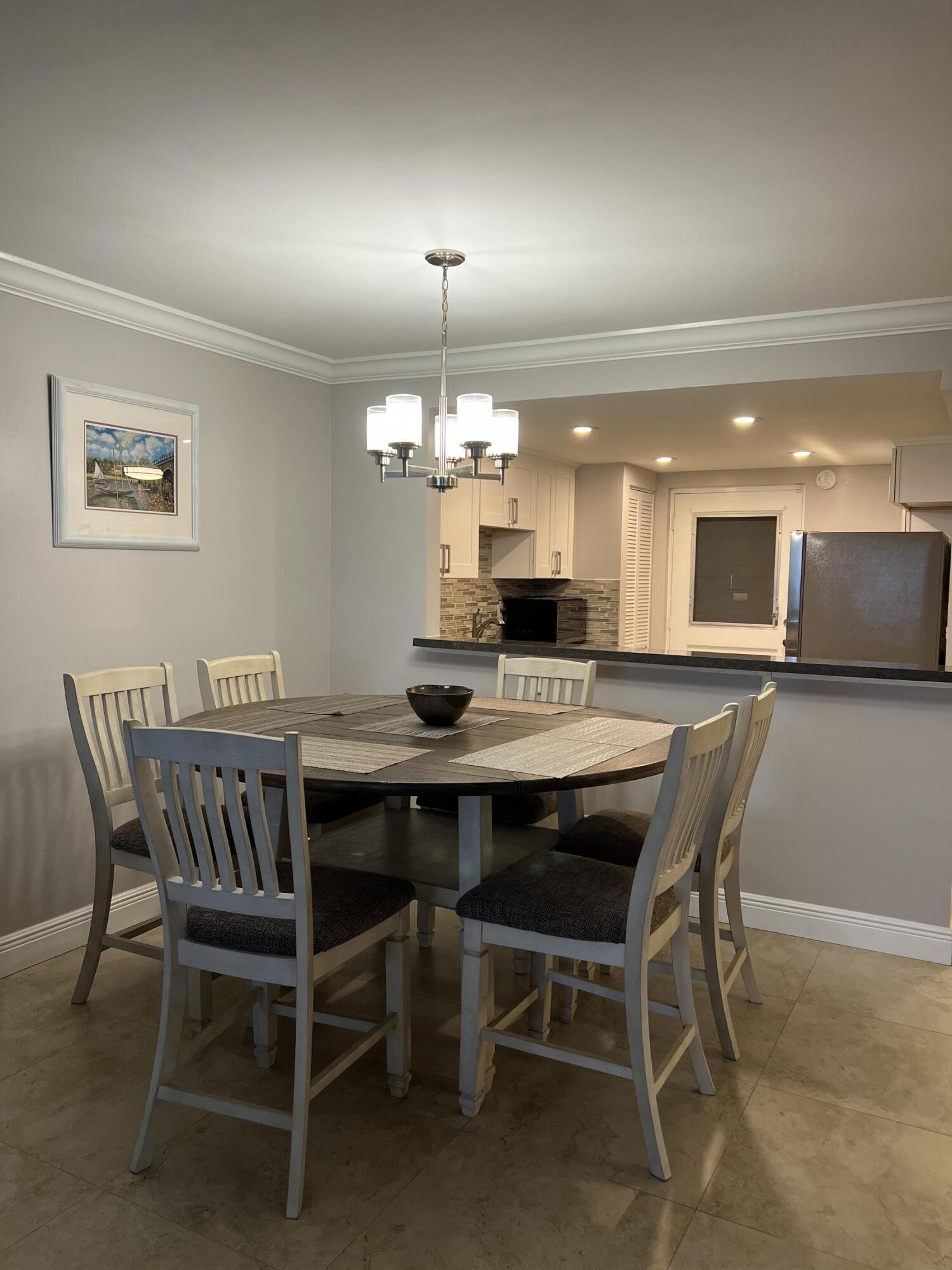 5700 Northwest 2nd Avenue, Unit 412 Boca Raton, FL 33487 - Photo 5 of 17 LIVING ROOM INTO DINING