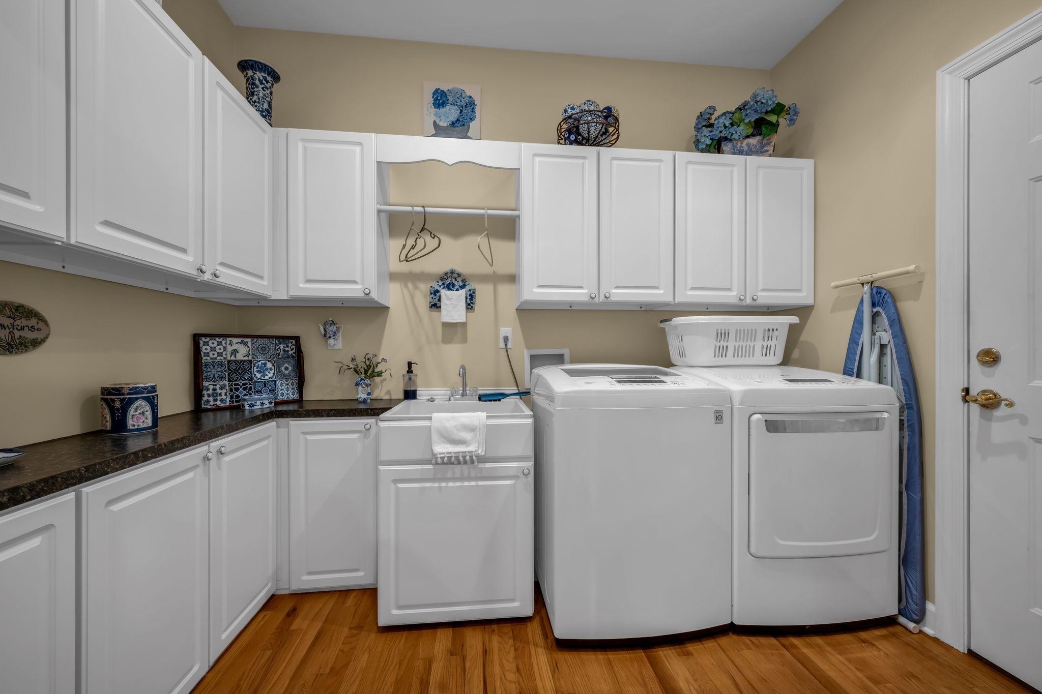 1270 Meeks Cemetery Road Burns, TN 37029 - Photo 31 of 44 a kitchen with a white cabinets and sink with wooden floors