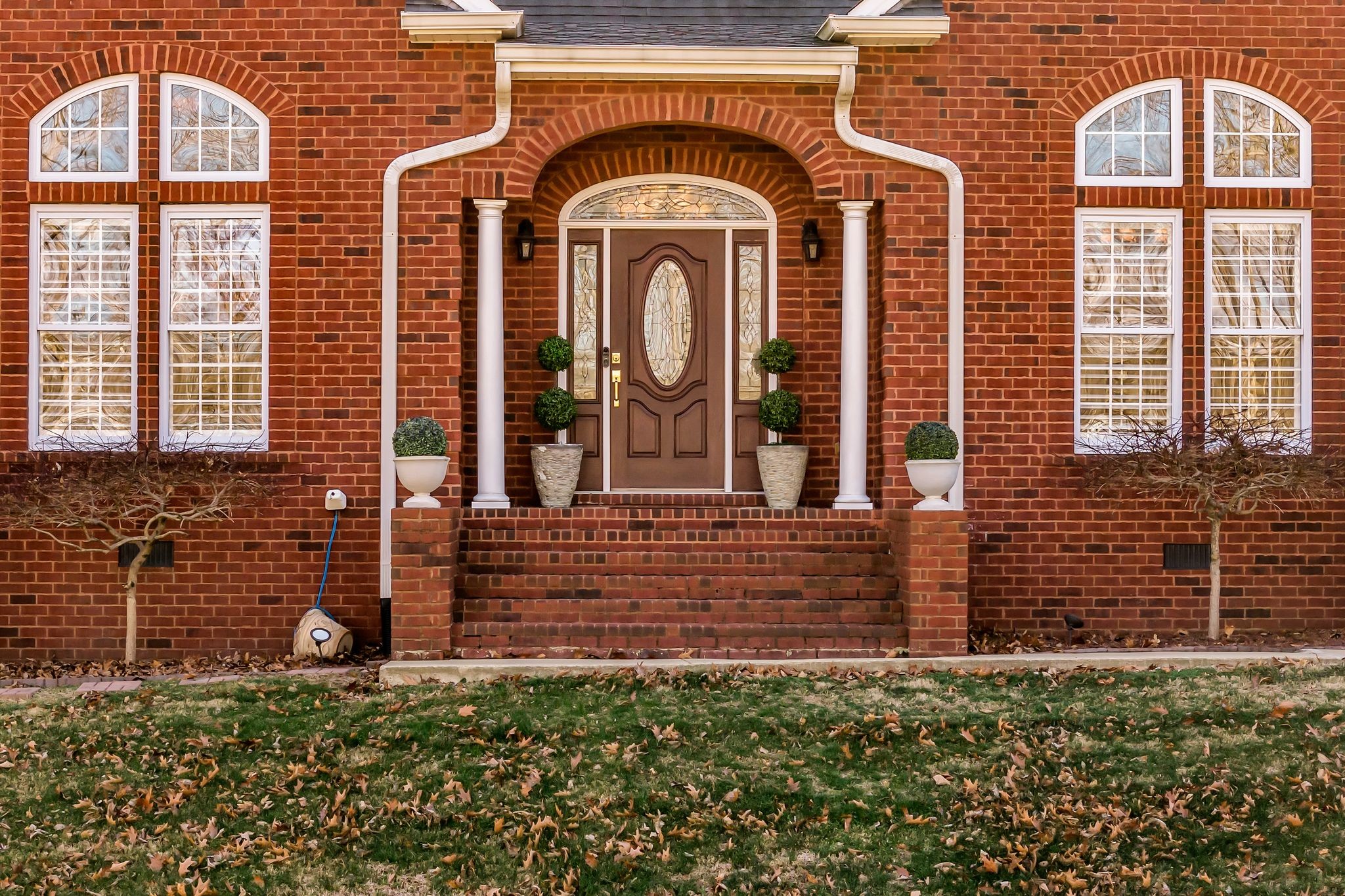 1270 Meeks Cemetery Road Burns, TN 37029 - Photo 5 of 44 a view of a brick house with large windows