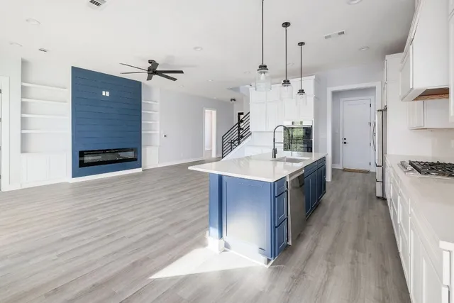 a bathroom with a double vanity sink a mirror and a shower