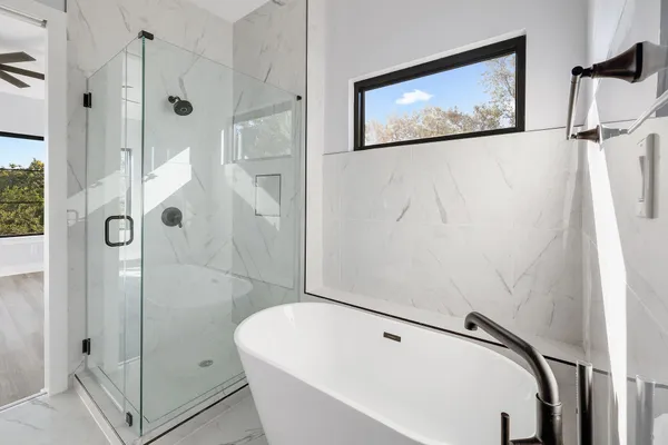 a bathroom with a white tub and shower