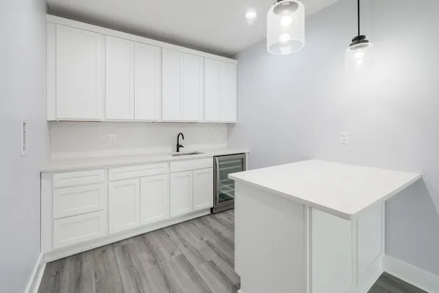 a kitchen with a white cabinets stove and sink