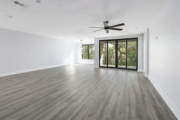 wooden floor in an empty room with a window