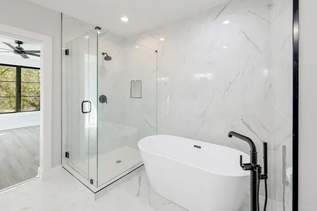 a bathroom with a bathtub and a shower