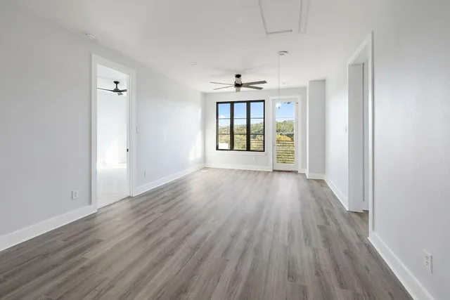 wooden floor in an empty room with a window