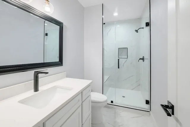 a bathroom with a sink toilet and shower