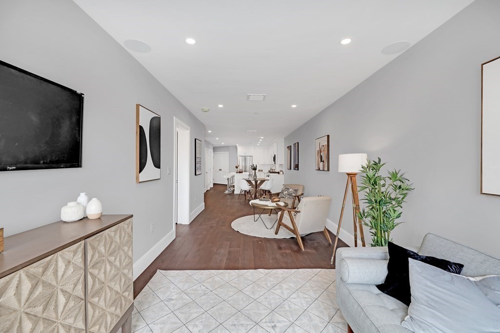 480 West Broadway, Unit 103 Boston, MA 02127 - Photo 12 of 19 a living room with furniture and a flat screen tv