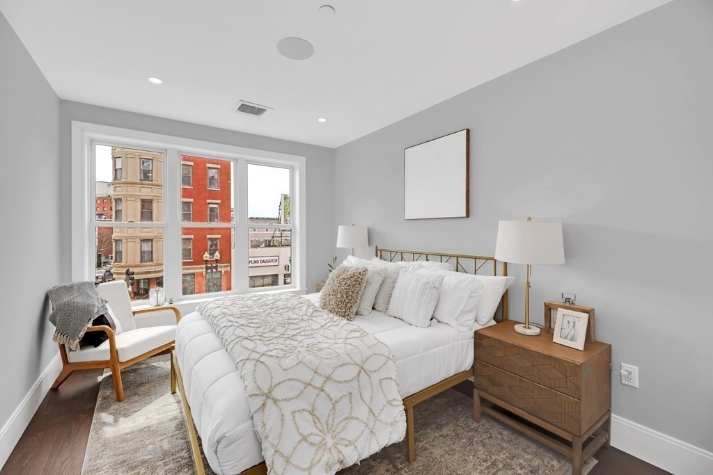 480 West Broadway, Unit 103 Boston, MA 02127 - Photo 3 of 19 a bedroom with a bed and a couch