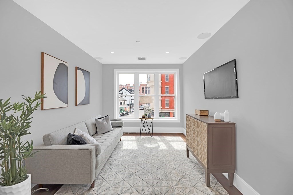 480 West Broadway, Unit 103 Boston, MA 02127 - Photo 4 of 19 a living room with furniture and a flat screen tv
