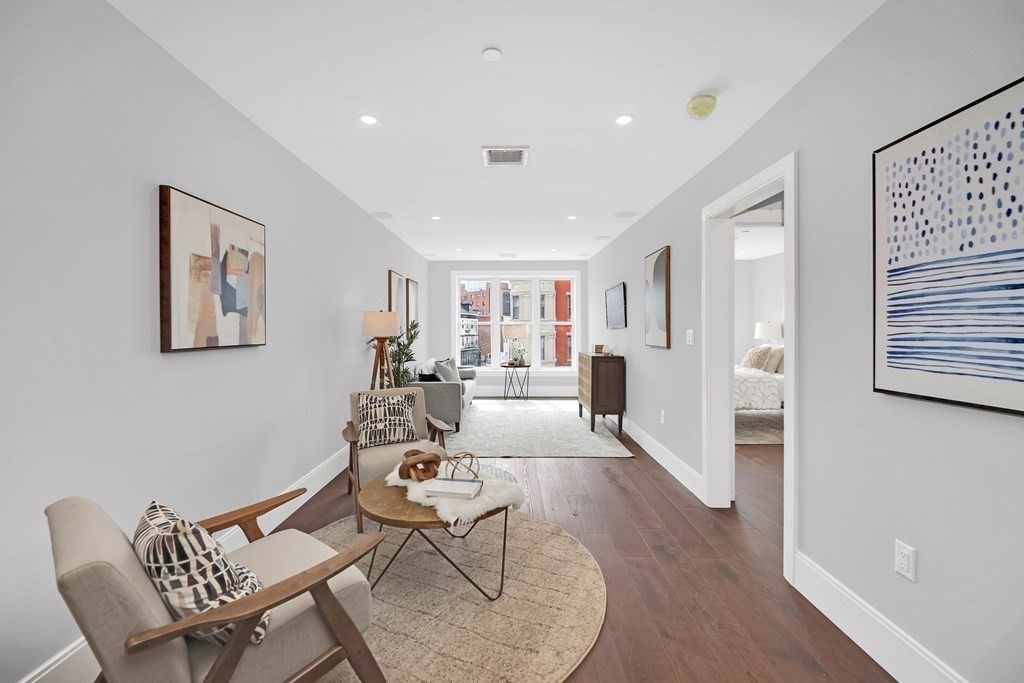 480 West Broadway, Unit 103 Boston, MA 02127 - Photo 10 of 19 a living room with furniture and a wooden floor