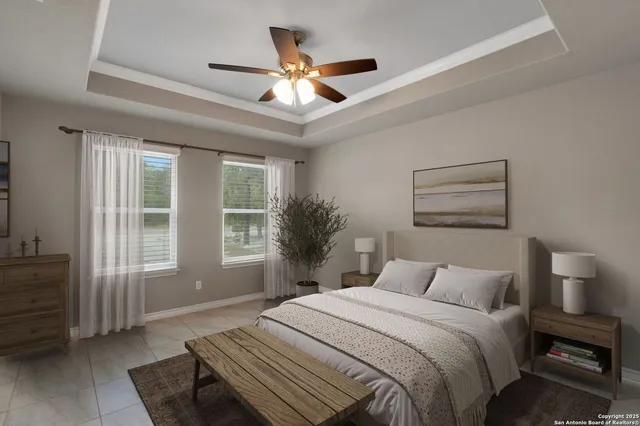 an empty room with chandelier fan and windows