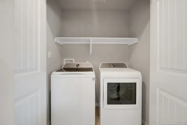a view of a terrace with lawn chairs and wooden fence