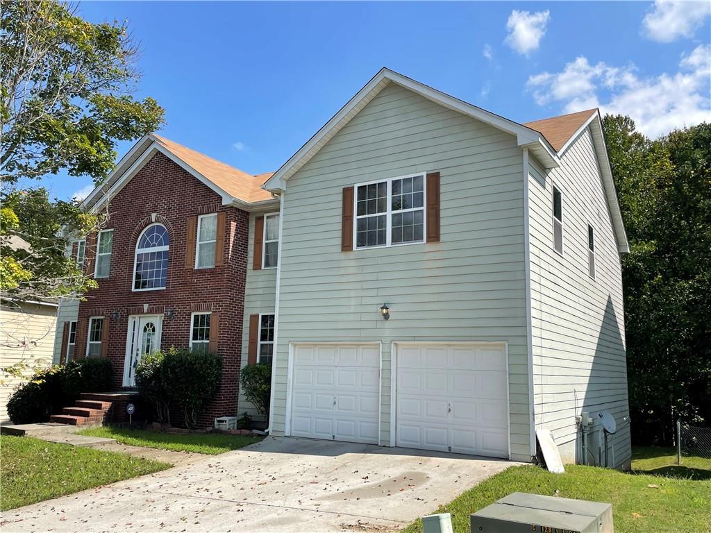 3244 Timber Ridge Atlanta, GA 30349 - Photo 1 of 1 a front view of a house with a yard