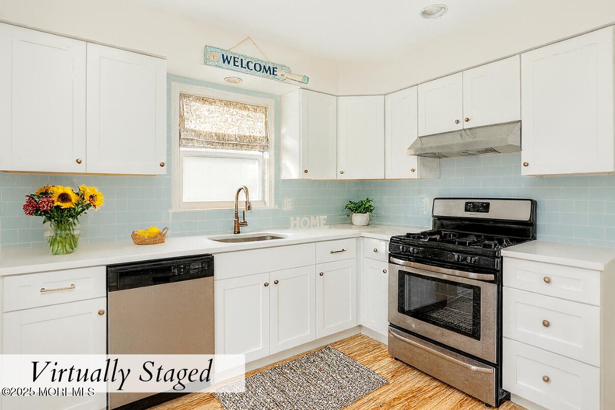 313 Shuster Avenue Seaside Heights, NJ 08751 - Photo 11 of 34 a kitchen with granite countertop white cabinets and white appliances