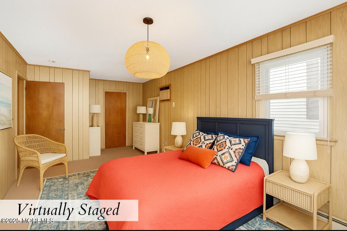 313 Shuster Avenue Seaside Heights, NJ 08751 - Photo 16 of 34 a spacious bedroom with a bed and wooden floor