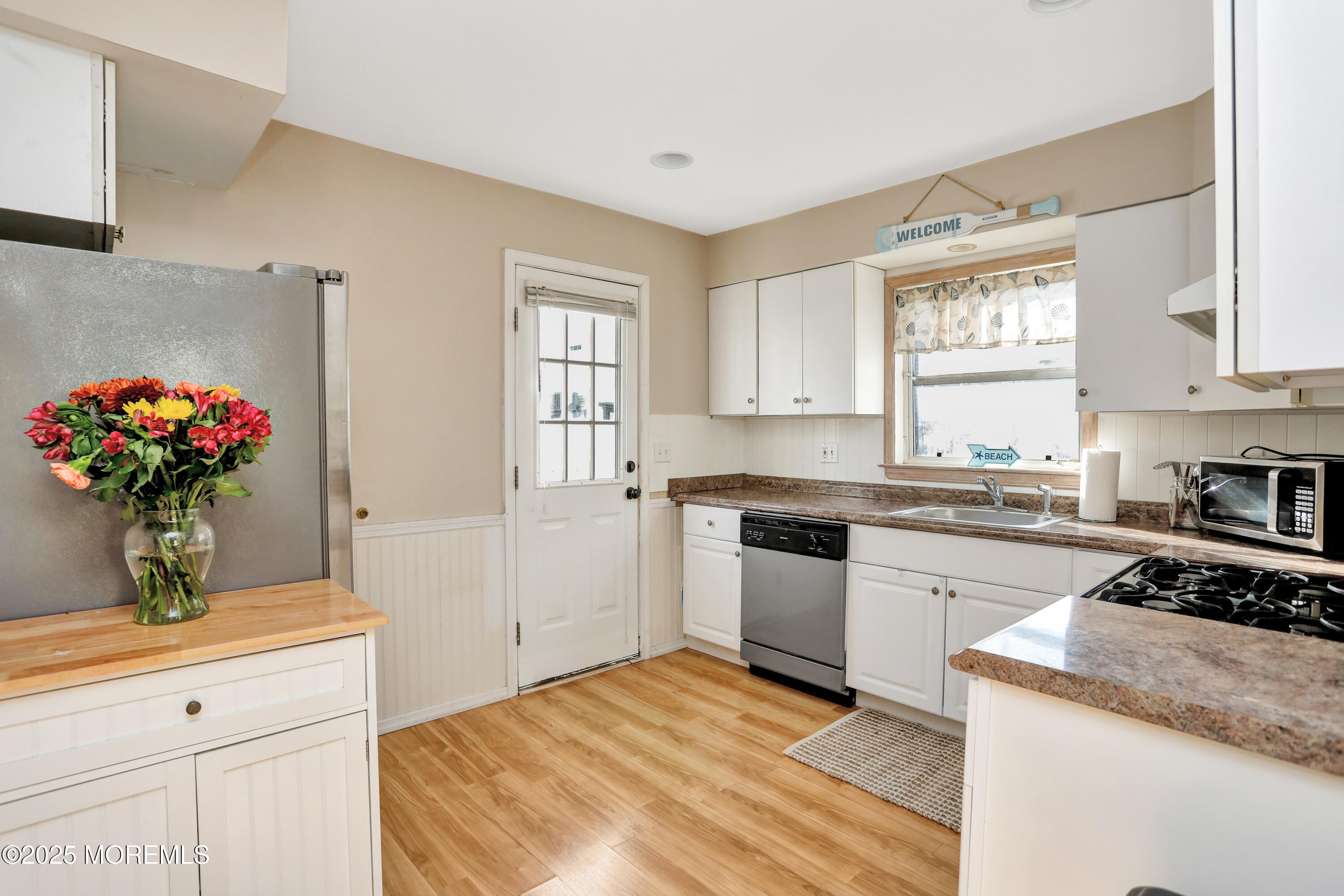 313 Shuster Avenue Seaside Heights, NJ 08751 - Photo 9 of 34 a kitchen with a sink stove and cabinets