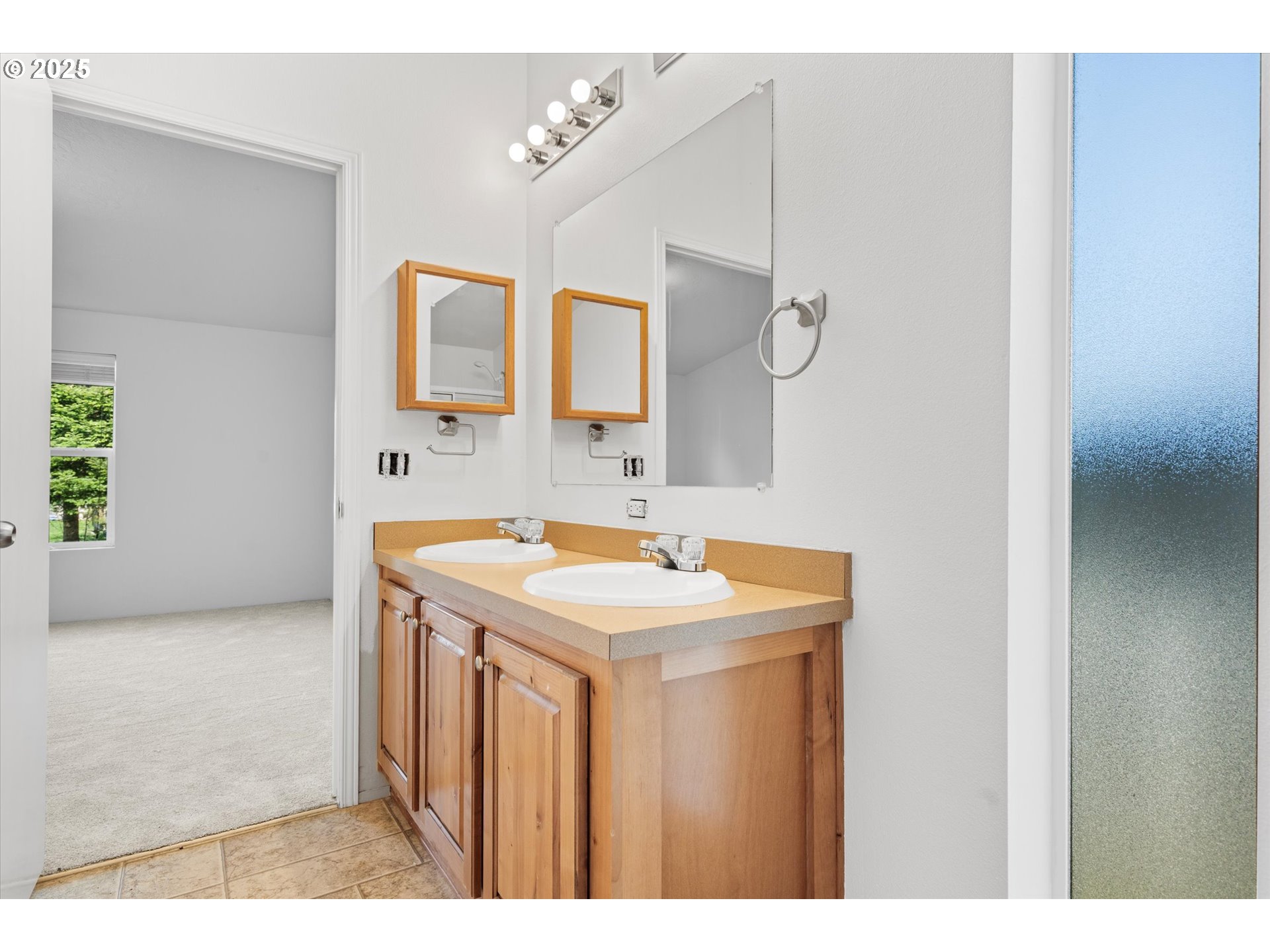 13996 Holcomb Boulevard Oregon City, OR 97045 - Photo 11 of 42 a bathroom with a sink vanity and a mirror