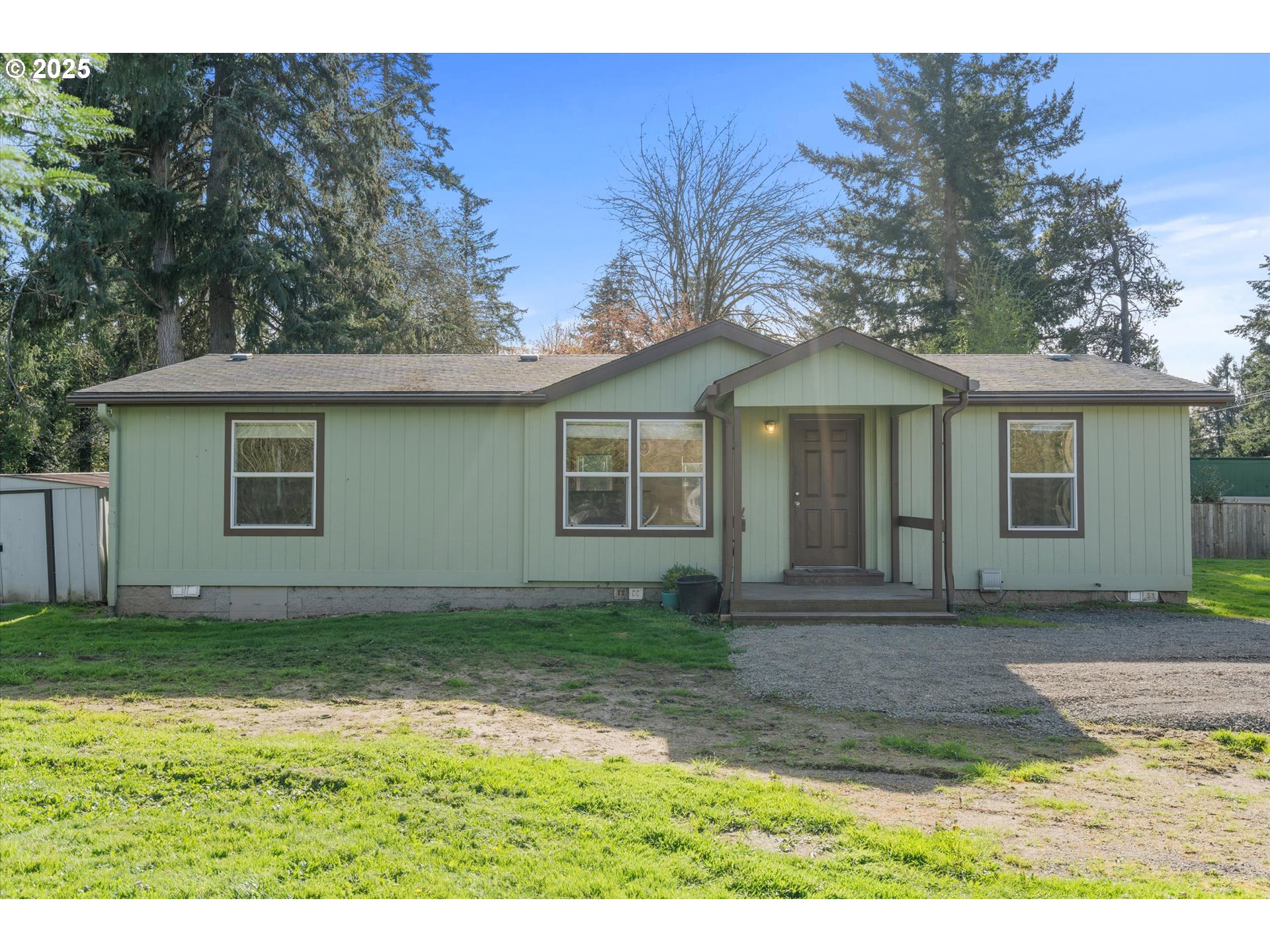 13996 Holcomb Boulevard Oregon City, OR 97045 - Photo 2 of 42 a front view of a house with a garden