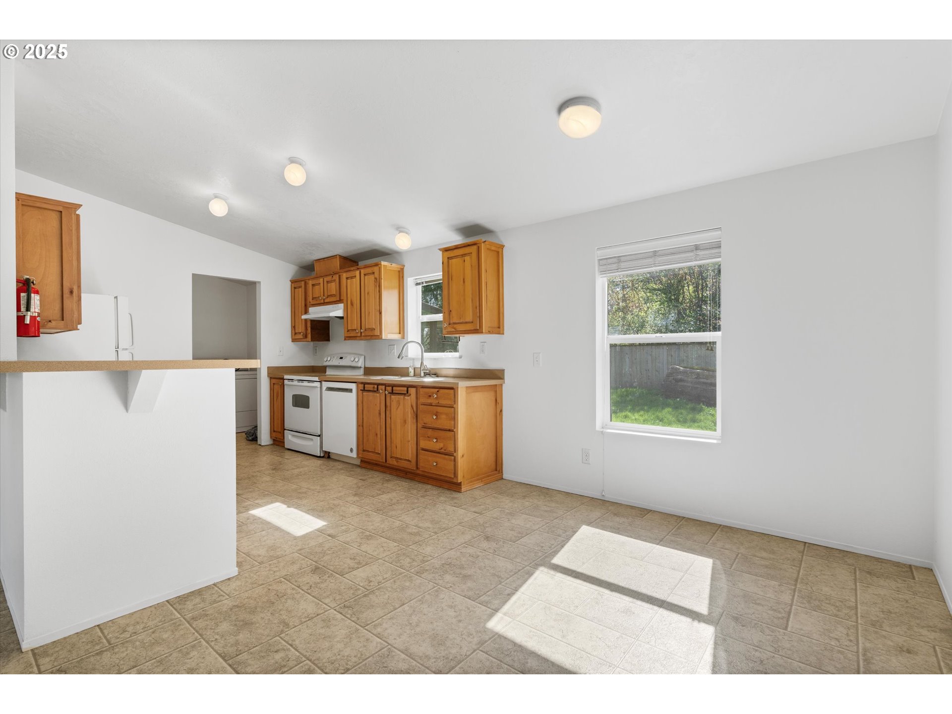 13996 Holcomb Boulevard Oregon City, OR 97045 - Photo 21 of 42 a kitchen with stainless steel appliances granite countertop a stove a sink dishwasher and a refrigerator