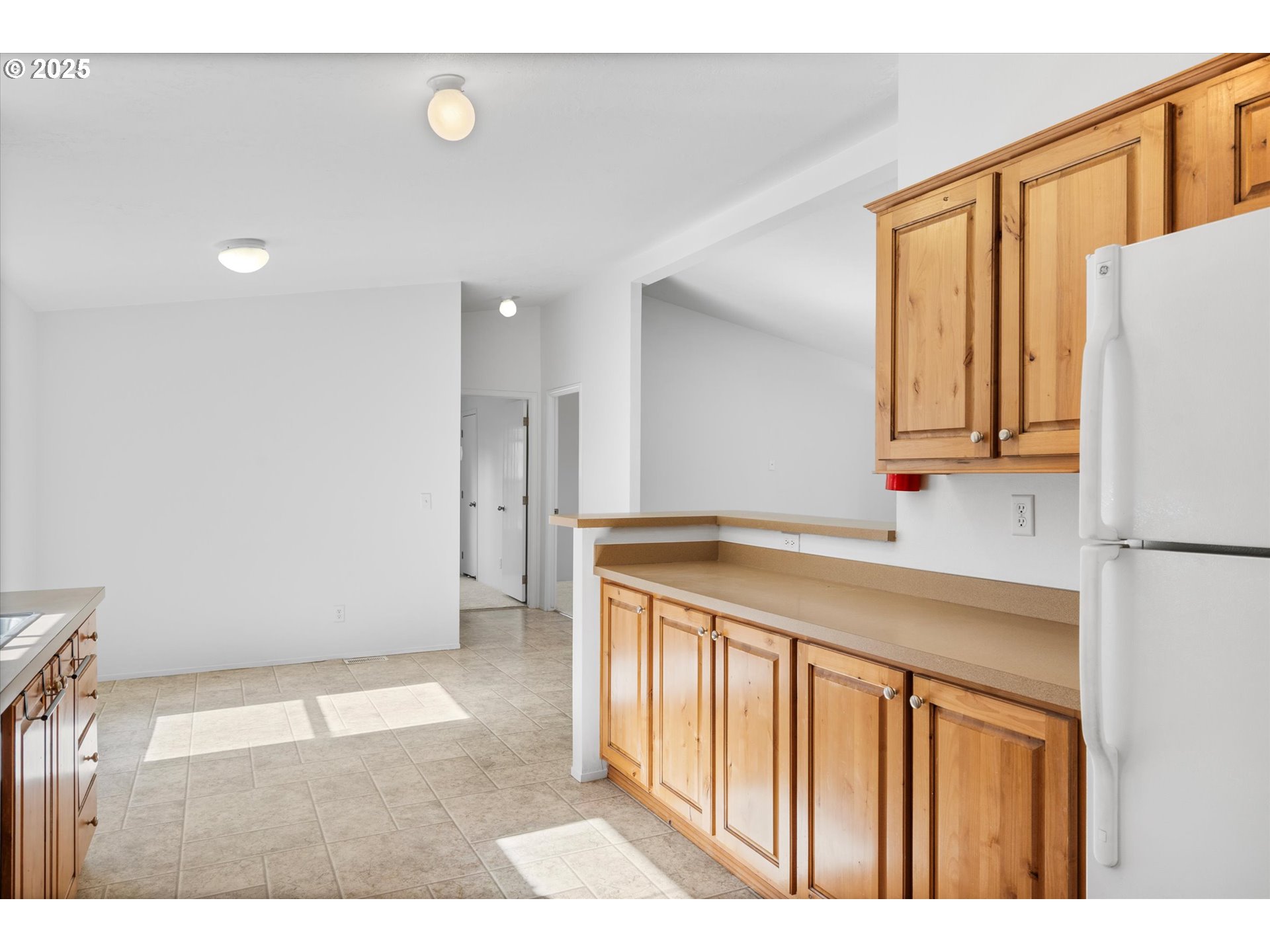 13996 Holcomb Boulevard Oregon City, OR 97045 - Photo 23 of 42 a kitchen with a refrigerator and a sink